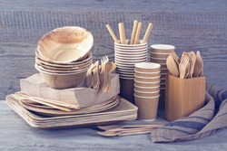 Eco friendly disposable tableware on a grey background