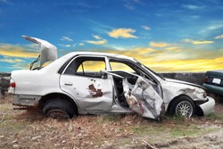 side view of crash car with blue sky