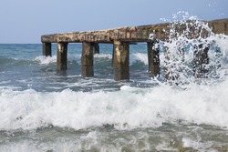 The old thrown concrete pier on the seashore