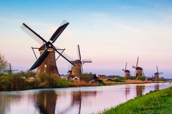 breathtaking beautiful inspirational landscape with windmills in Kinderdijk, Netherlands at sunset. Fascinating places, tourist attraction.
