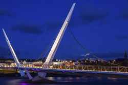 Full moon rising by Peace Bridge in Derry. Derry, Northern Ireland, United Kingdom.