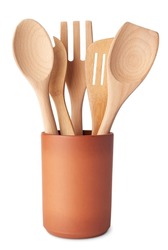 Set of wooden kitchen utensils, spoon, fork and spatula, in a terracotta container, isolated on white background