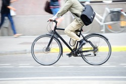 Man in suit on bike in profile