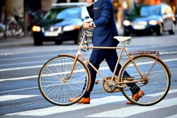 Man in perfect suit and old bike, typical Stockholm Scene