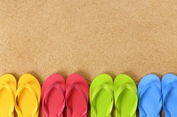 Row of flip flop sandals, summer beach border, copy space.