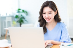 telework concept - Asian woman use computer to work and has a video meeting at home