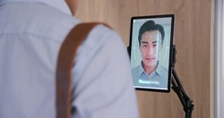 facial recognition concept - Asian businessman using face scanner to clock in work and check body temperature then unlock office door 