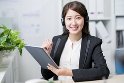 asian customer service representative work and smile at you in the office