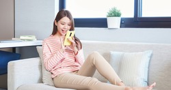 asian teen girl use smartphone happily at home