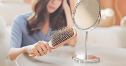asian girl worry about hair loss - with the comb 