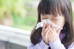 little girl get cold and blow her nose,  asian