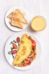 Omelette with vegetables and ham, top view