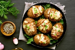 Delicious baked potatoes with bacon, green onion and cheese. Dish for dinner. Close up view. Top view, flat lay 