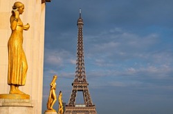 View of the Eiffeltower in Paris, France, with golden statues in front