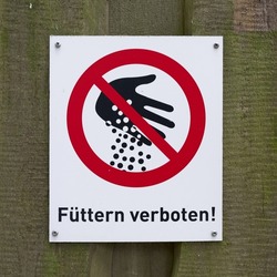  Sign with the inscription feeding prohibited on the fence in a zoo in Germany                              