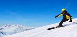 Professional alpine skier skiing downhill in high mountains of Alps