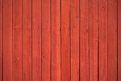 Old, red grunge wood vertical panels on a rustic barn
