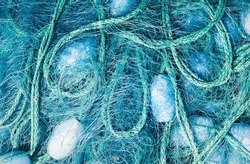 Close view of some blue fishing net floaters on the docks 