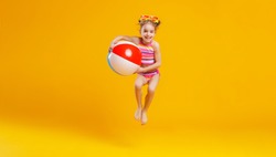  funny happy child   jumping in swimsuit and swimming glasses on colored background
