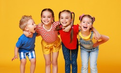  group of cheerful happy children on a colored yellow background
