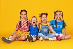 group of cheerful happy children on a colored yellow background