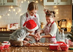 happy funny family mother and children  bake christmas cookies on cozy kitchen at home