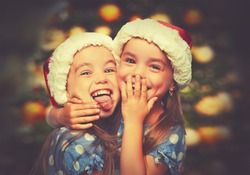 Christmas Happy funny children twins sisters hugging 