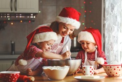 happy family mother and children son and daughter bake cookies for Christmas