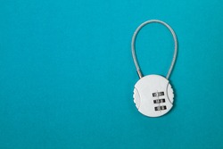 Small silver iron cipher lock with a coded set on blue background