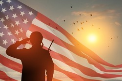 USA army soldier saluting on a background of sunset or sunrise and USA flag. Greeting card for Veterans Day, Memorial Day, Independence Day. America celebration. Closeup. 3D-rendering.