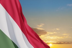 Waving flag of Hungary in sunset sky. Independence day, National day. Background with place for your text.