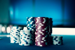 Piles of chips on the poker table, winning and casino concept