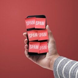 Hand holding a smartphone full of spam texts, cybersecurity concept