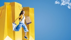 Cheerful young woman running and holding shopping bags, sales and fashion concept, blank copy space