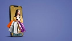 Happy young woman holding many shopping bags in a smartphone screen, online shopping offers, blank copy space