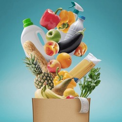 Assorted fresh groceries falling in a paper bag, grocery shopping concept