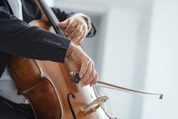 Classical music professional cello player solo performance, hands close up, unrecognizable person
