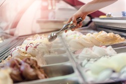 Woman serving ice cream in Confectionery shop