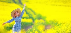 Girl in a long vintage dress hat in a field of flowers, happy summer sunny freedom female