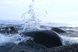 Splashes from the waves bumping against the rocky shore