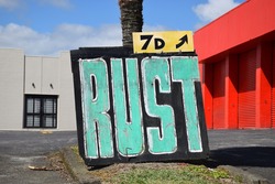 A chalk board sign with big letters saying RUST