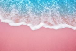 Summer pink sands beach with soft blue ocean wave and beautiful fine sand pink color