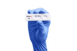 Scientist hand showing rapid test kit for viral disease COVID-19 2019-nCoV with positive result. Lab card kit test for viral sars-cov-2 virus. Rapid test device coronavirus