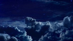 beautiful starry night sky with large clouds