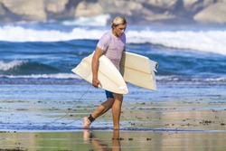 surfer with broken surfboard