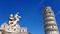 View of an ancient sculpture in front of the Pisa Cathedral (Duomo di Pisa) in Pisa, Italy. It is located in Miracoli Square (Piazza dei Miracoli).