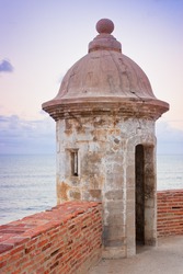 Lookout tower at El Morro Castle fort in old San Juan, Puerto Rico at sunset.