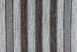 Wool rustic rug with gray, white and black stripes, texture background.