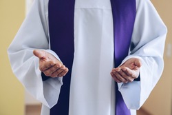 Priest hands in praying or blessing gesture