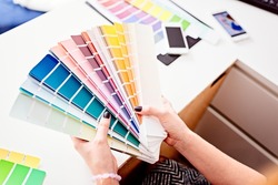 Woman designer or architect choosing color from color palette